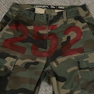 camo cargo pants. customized with 252 in red paint across front waist.